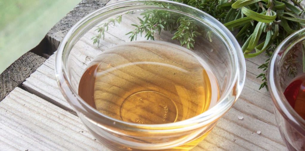 White vinegar breaks down sticker residue
