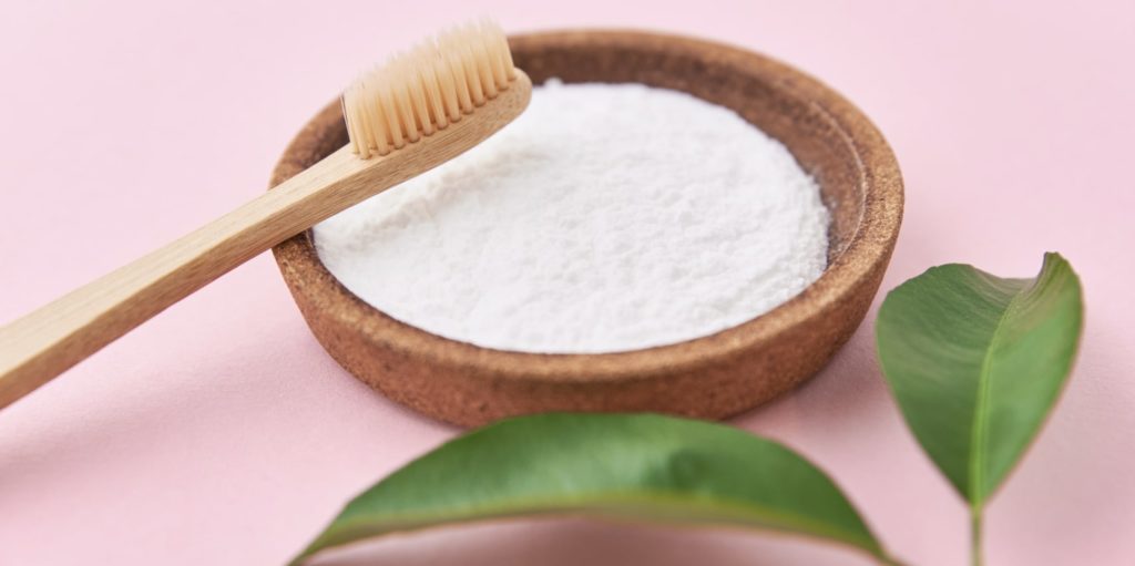 Rub the baking soda paste onto the grout